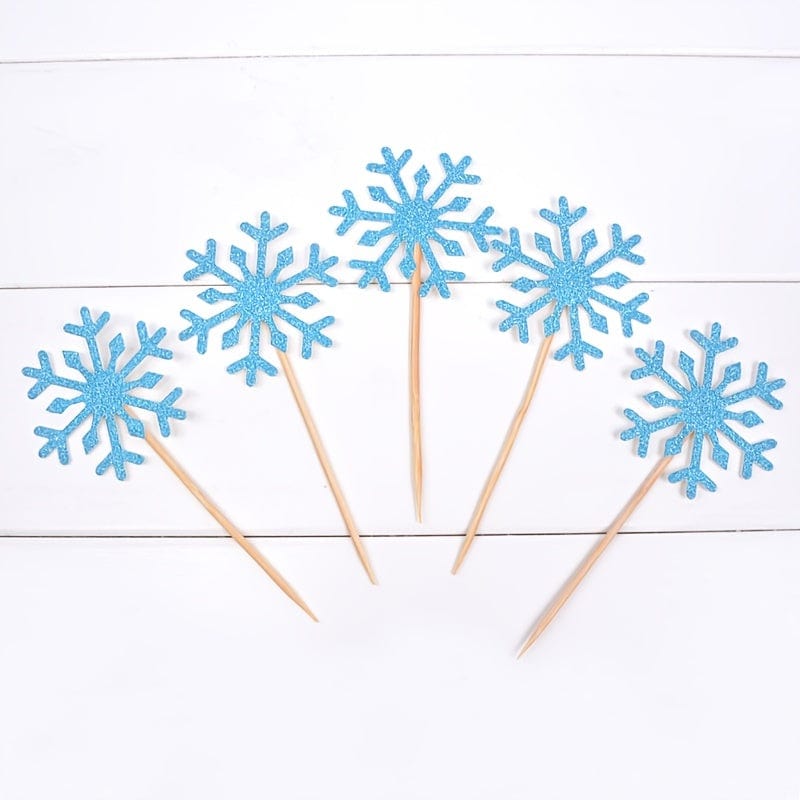 5  blue Snow flake cake toppers on counter