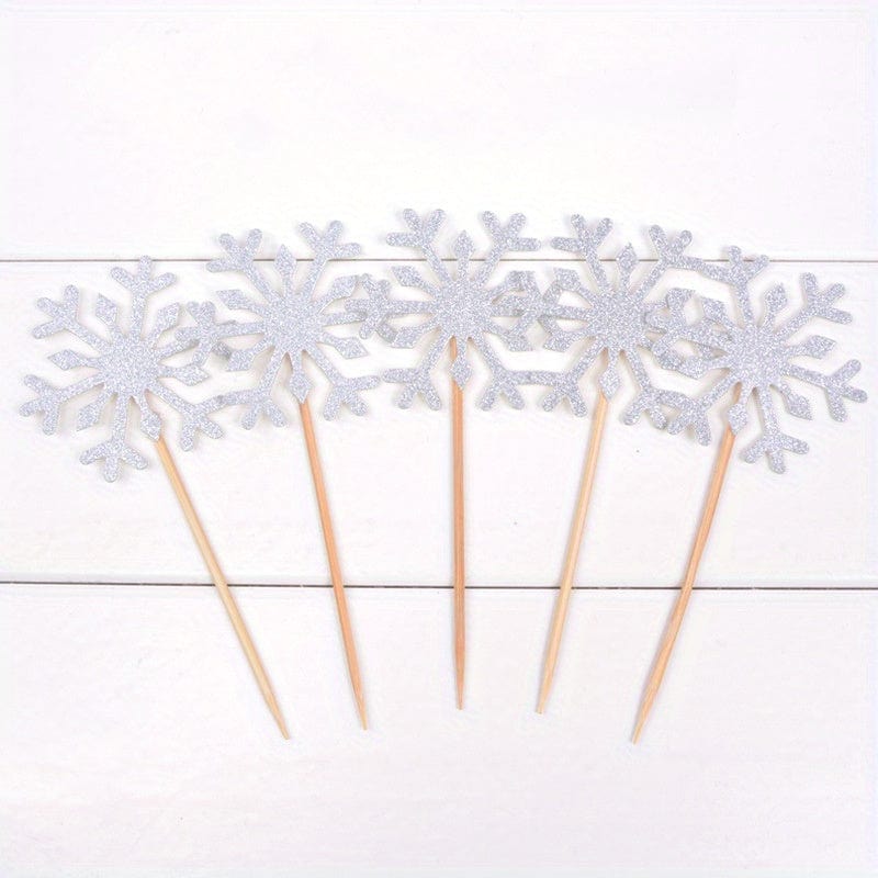 5  Silver Snow flake cake toppers on counter