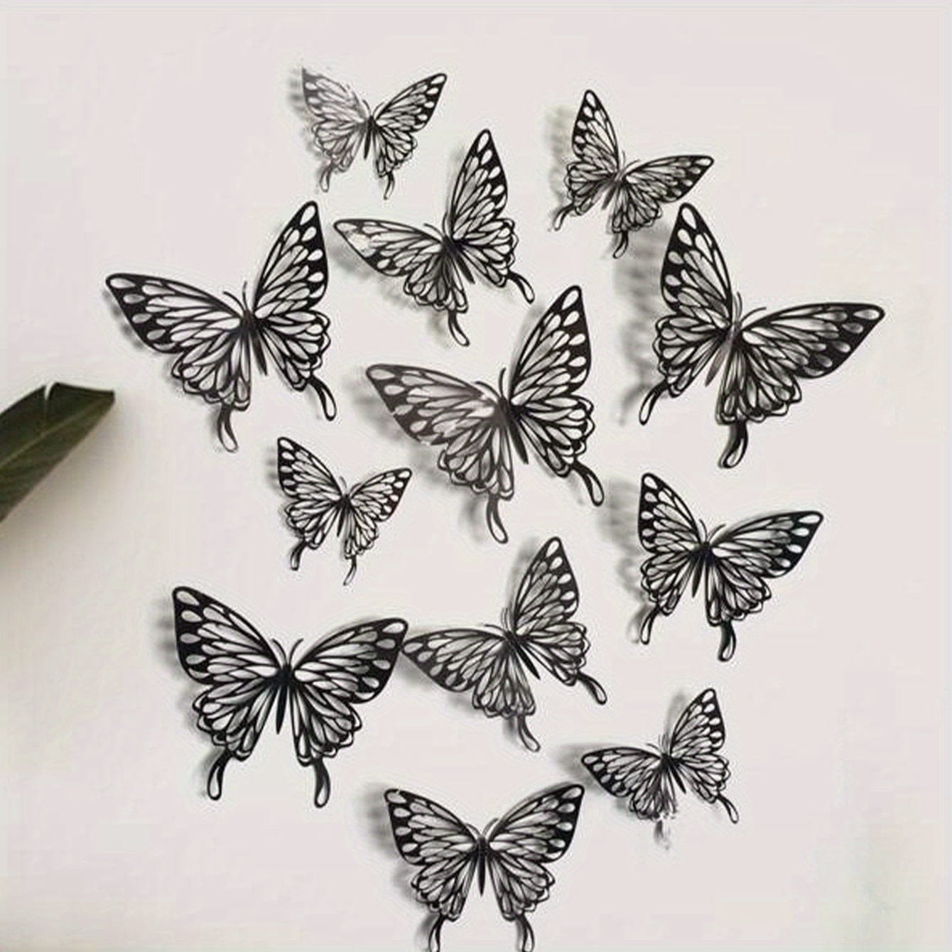 Black butterflies on white wall