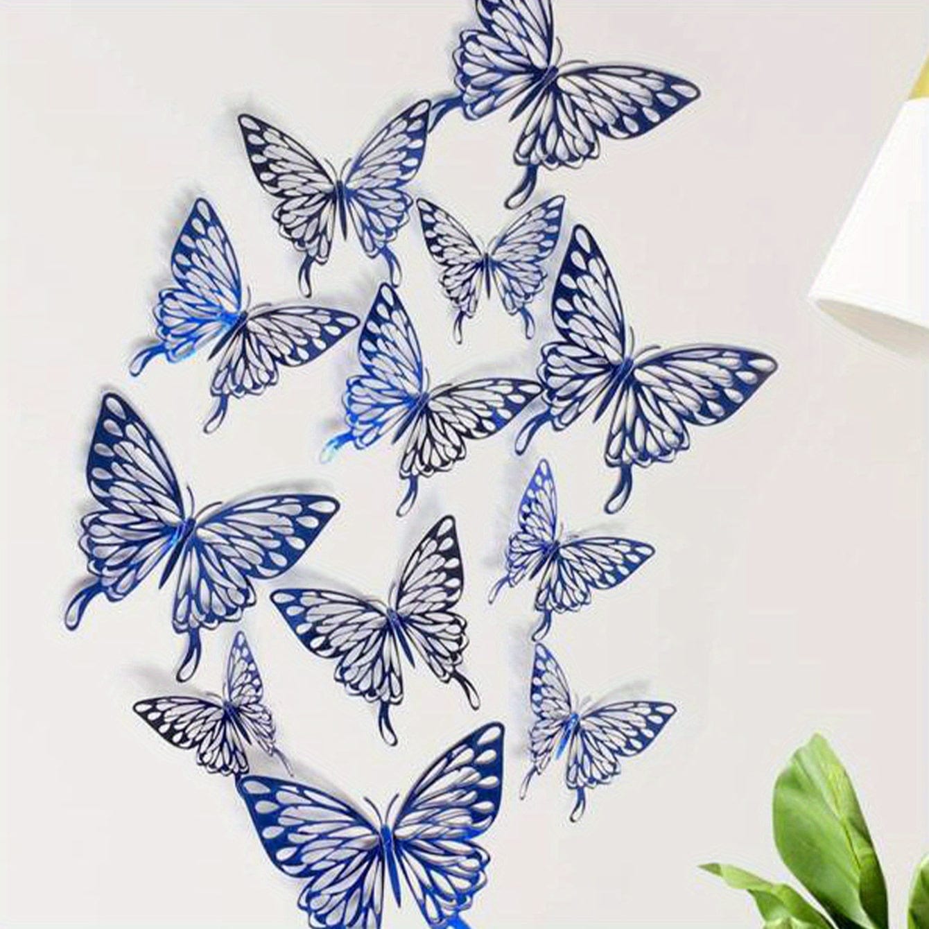 Ble butterflies on white wall with lamp