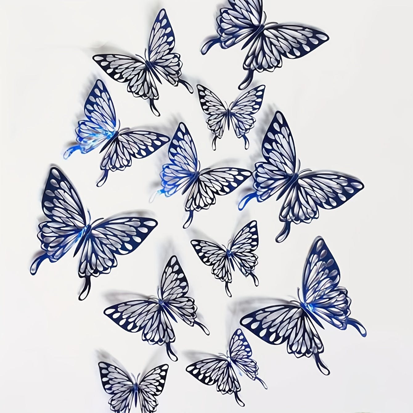 Black and blue butterflies on white wall