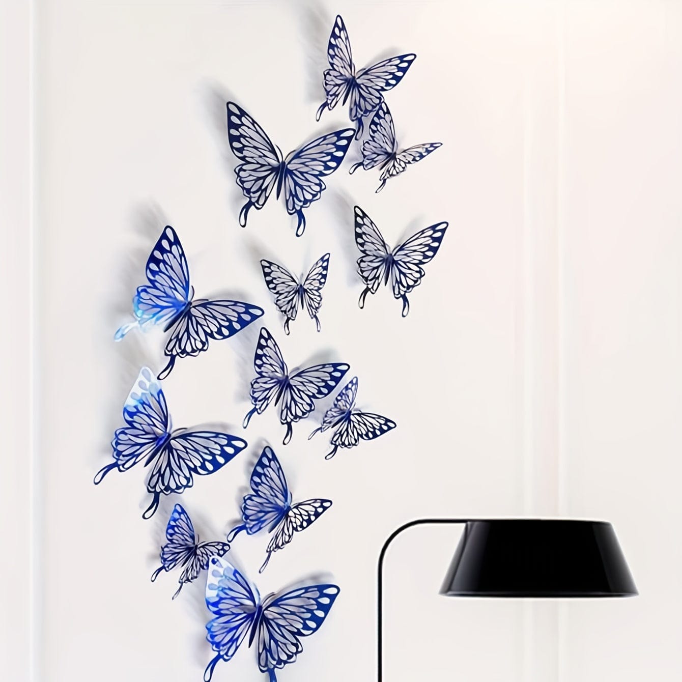 Blue butterflies on white wall