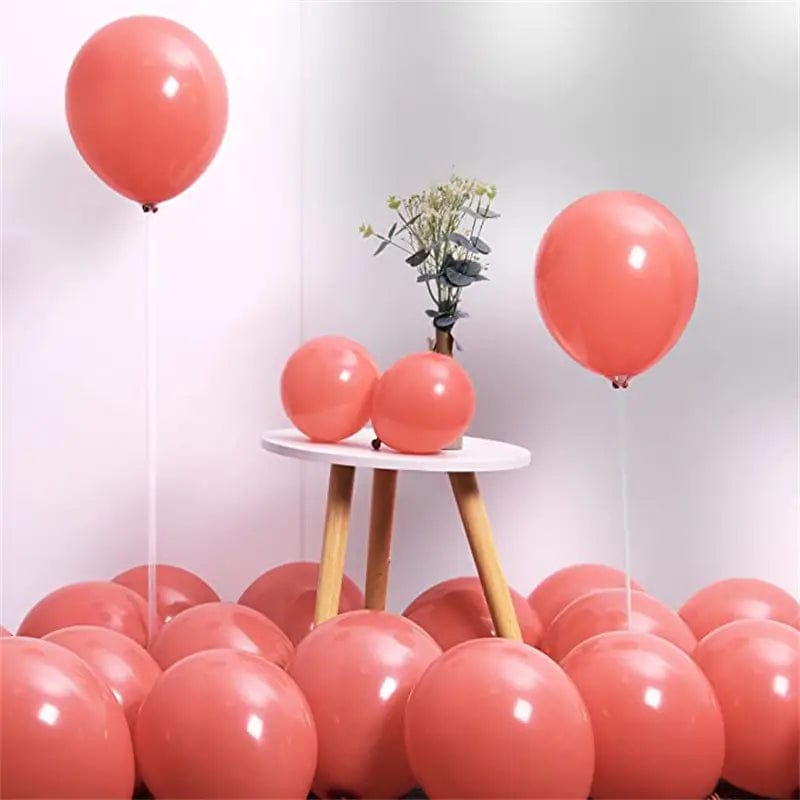 Blush colored 10 inch balloons in corner of room