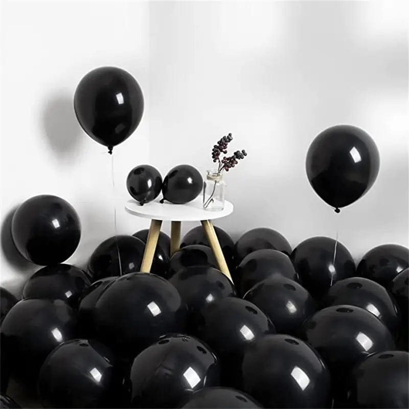 Black 10 inch balloons in corner of room