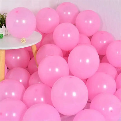 Pink 10 inch balloons in corner of room
