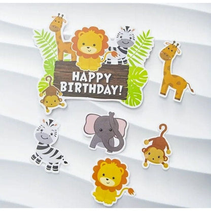 jungle themed cake decorations laying on white background