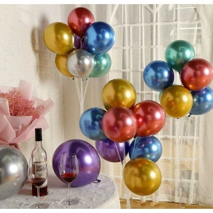 Metallic balloon varieties on table with wine glasses