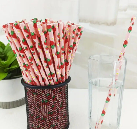 strawberry's on a group of pink paper straws