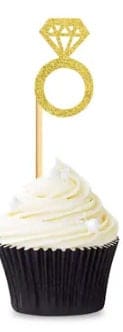 Glitter gold engagement ring pick on a cupcake